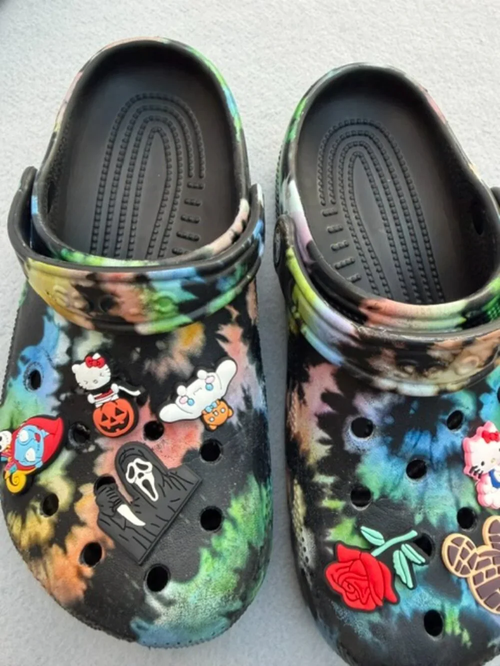 The product is a pair of Crocs Kids Size J 3 Black Tie-Dye Classic Clog Sandals